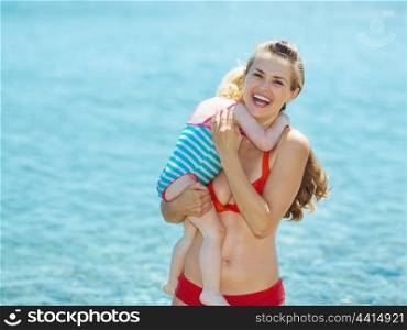 Portrait of mother and baby girl at seaside