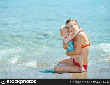 Portrait of mother and baby girl at seaside