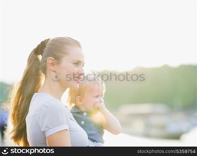 Portrait of mother and baby looking on copy space