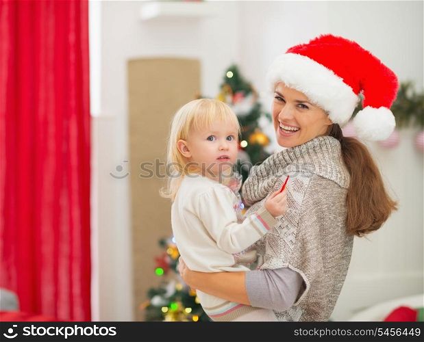 Portrait of mother and baby near Christmas tree