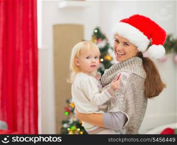 Portrait of mother and baby near Christmas tree