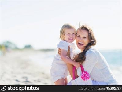 Portrait of mother and baby on sea shore
