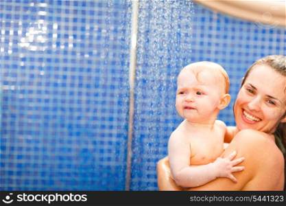 Portrait of mother and baby taking shower&#xA;