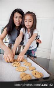 Portrait of mother and child in kitchen making cookies