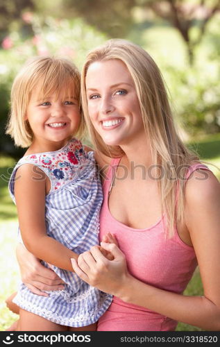 Portrait Of Mother And Child Relaxing In Park