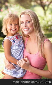 Portrait Of Mother And Child Relaxing In Park