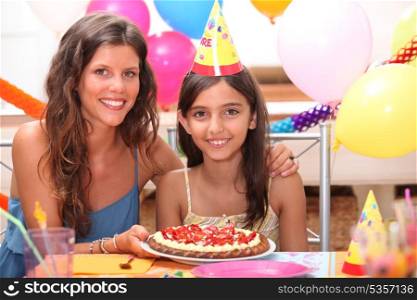 portrait of mother and daughter at birthday party