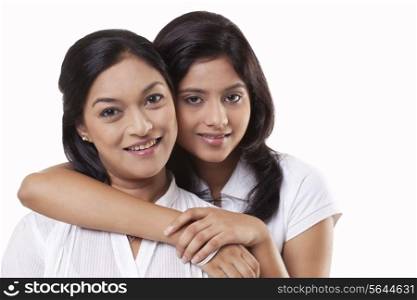 Portrait of mother and daughter embracing