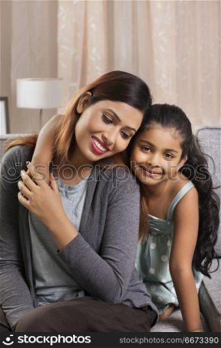 Portrait of mother and daughter embracing