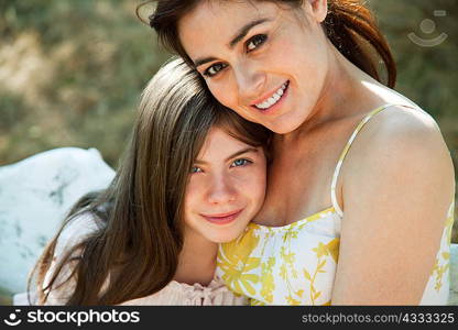 Portrait of mother and daughter hugging