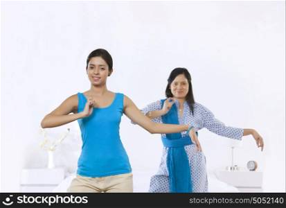 Portrait of mother and daughter in dance pose