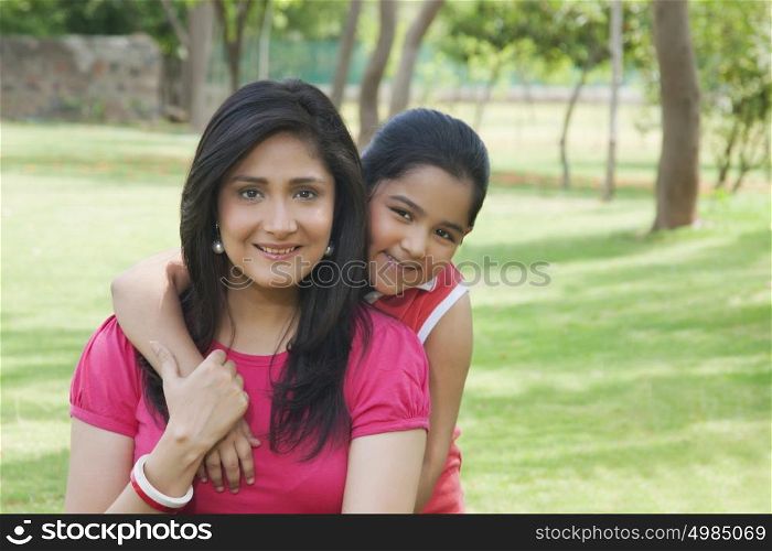 Portrait of mother and daughter in park