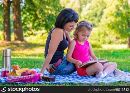 portrait of mother and daughter in the summer park