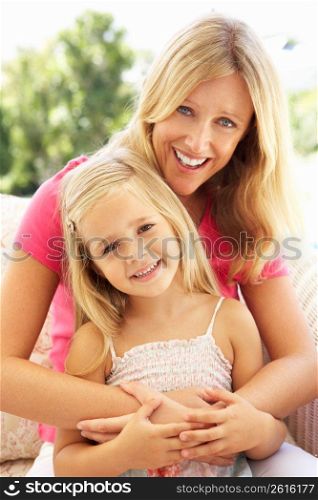 Portrait Of Mother And Daughter Relaxing On Sofa