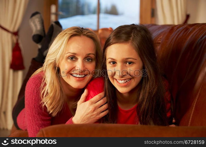 Portrait Of Mother And Daughter Relaxing On Sofa Together