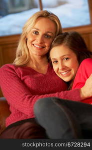 Portrait Of Mother And Daughter Relaxing On Sofa Together