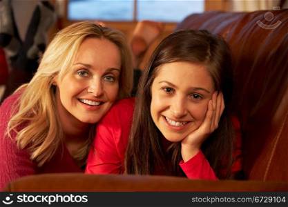 Portrait Of Mother And Daughter Relaxing On Sofa Together