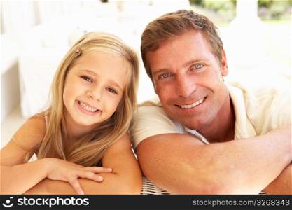 Portrait Of Mother And Daughter Relaxing Together On Sofa