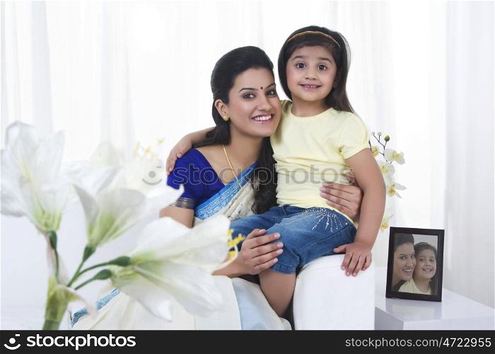 Portrait of mother and daughter smiling
