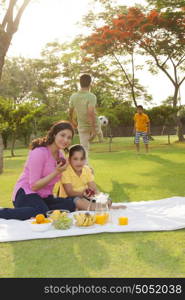 Portrait of mother and daughter with apple