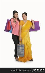 Portrait of mother and daughter with shopping bags