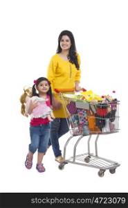 Portrait of mother and daughter with shopping cart