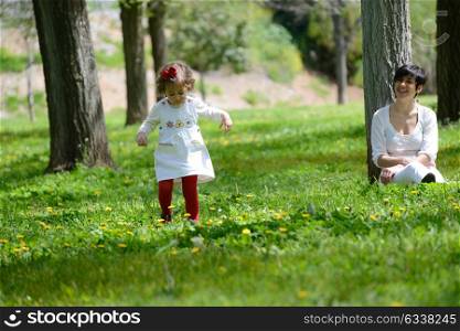 Portrait of mother and little girl playing in the park