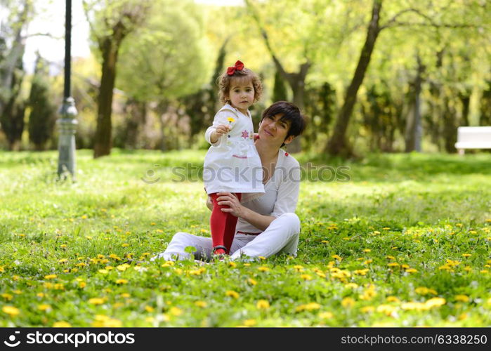 Portrait of mother and little girl playing in the park