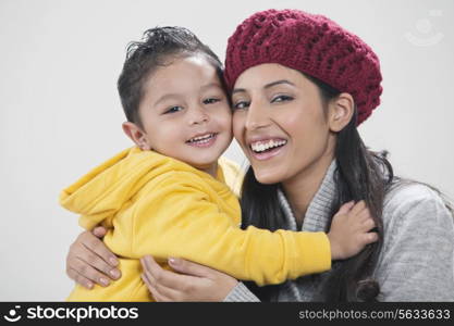 Portrait of mother and son embracing