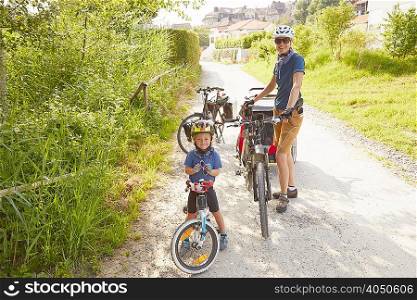 Portrait of mother and son with bicycles
