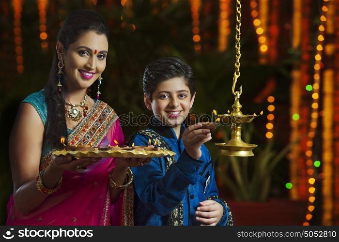 Portrait of mother and son with diyas
