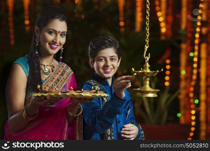 Portrait of mother and son with diyas