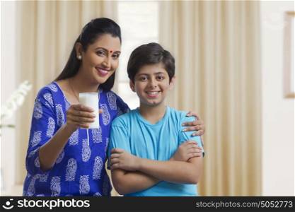 Portrait of mother and son with glass of milk