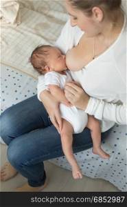 Portrait of mother breastfeeding her little baby