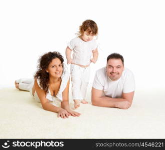 portrait of mother, father and their child together in studio