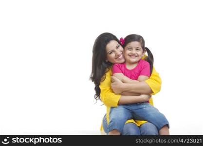 Portrait of mother hugging daughter