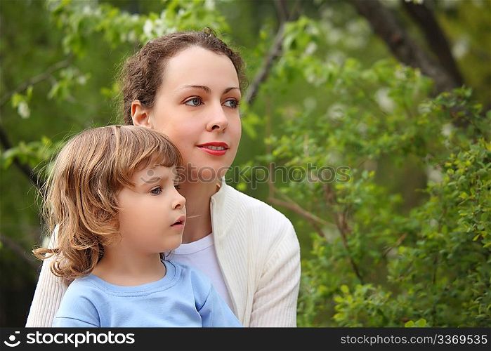 Portrait of mother with daughter in wood in summer