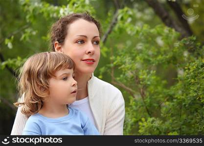 Portrait of mother with daughter in wood in summer