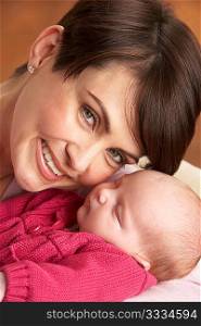 Portrait Of Mother With Newborn Baby At Home