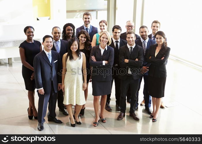 Portrait Of Multi-Cultural Office Staff Standing In Lobby