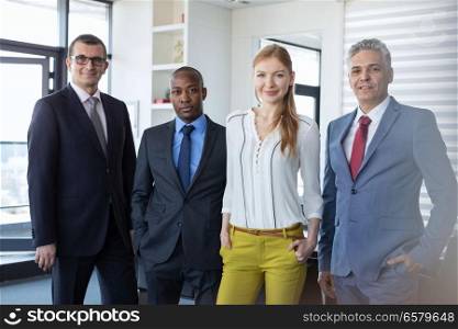 Portrait of multi-ethnic business people standing together in office