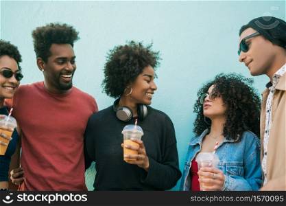 Portrait of multi-ethnic group of friends having fun together and enjoying good time while drinking fresh fruit juice.