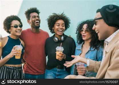 Portrait of multi-ethnic group of friends having fun together and enjoying good time while drinking fresh fruit juice.