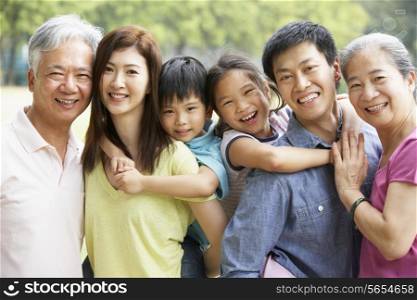 Portrait Of Multi-Generation Chinese Family Relaxing In Park Together