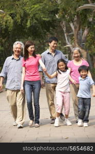 Portrait Of Multi-Generation Chinese Family Walking In Park Together