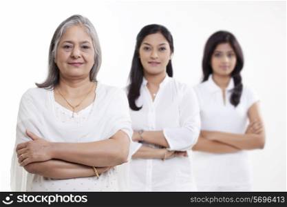 Portrait of multi generation family standing over white background