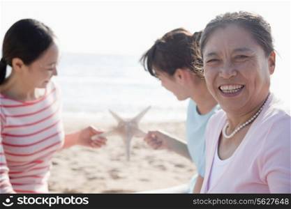 Portrait of multi- generational family on the beach, starfish