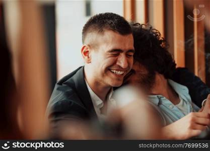 Portrait of multiethnic diverse gay LGBT romantic male couple embracing and showing their love and smoking cigarette. High quality photo. Portrait of multiethnic diverse gay LGBT romantic male couple embracing and showing their love