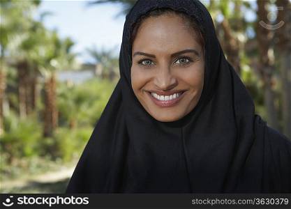 Portrait of muslim woman in black headscarf