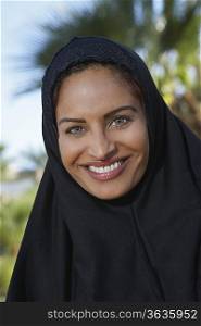 Portrait of muslim woman in black headscarf